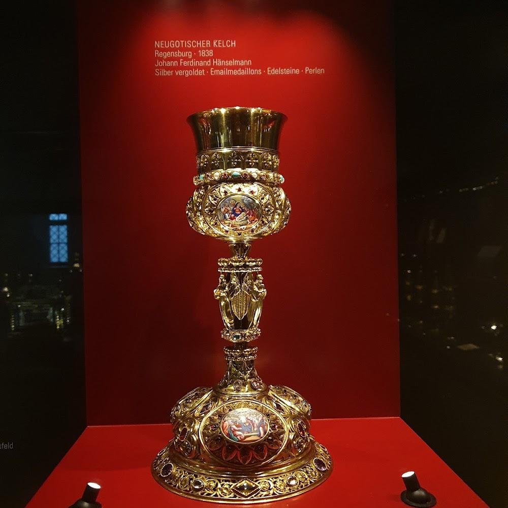 A gold chalice with ornate detail.  The label says 